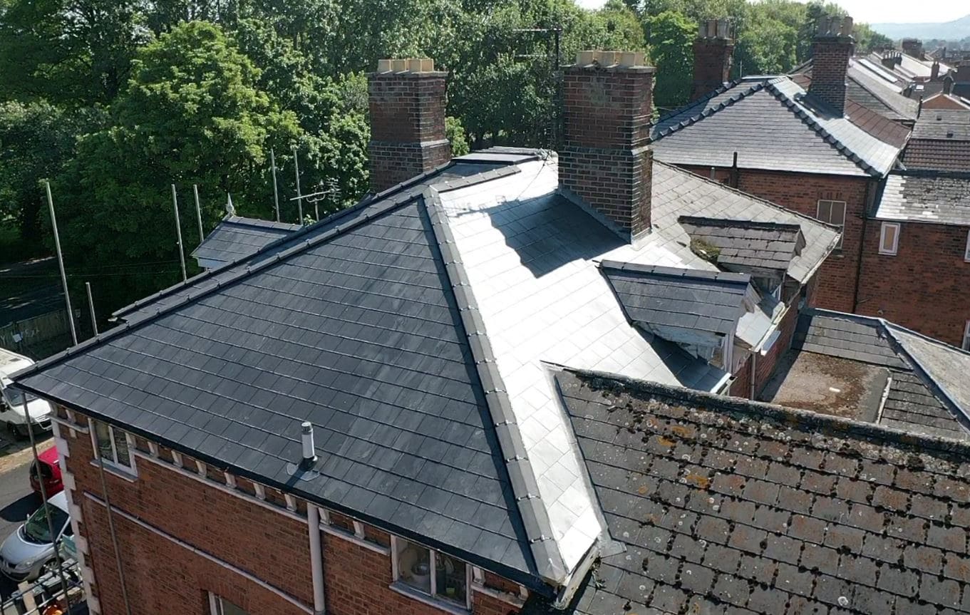Aerial view of a completed slate re-roof with chimney stacks, by Creative Roofing in Oxfordshire